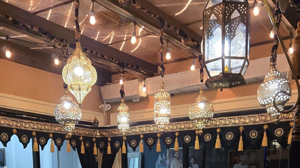 Ornate hanging Moroccan lanterns and warm ambient lighting for a traditional Indian wedding setting.