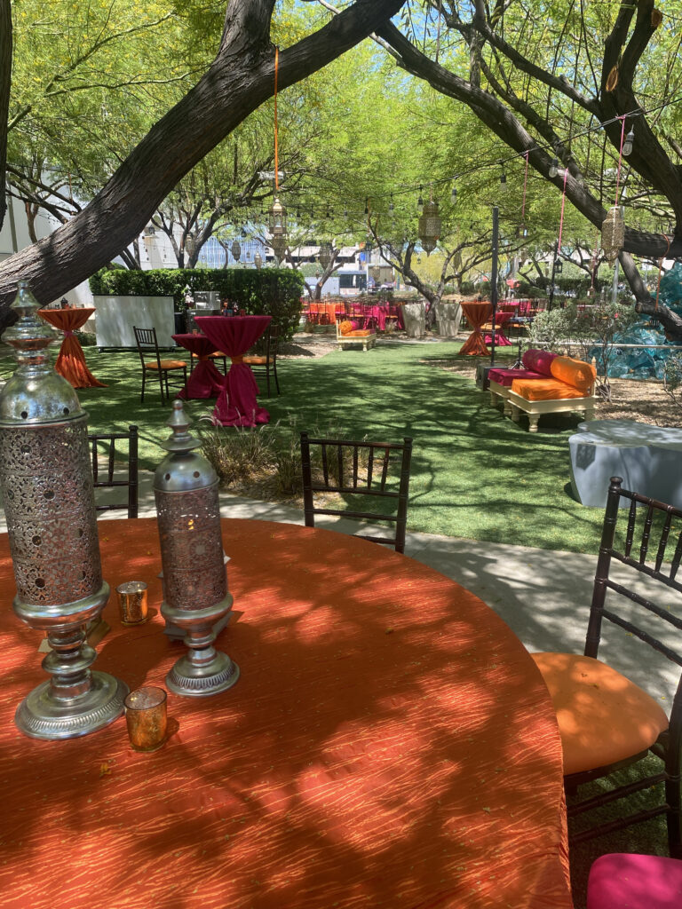 Outdoor Indian event lantern decor with cocktail tables and colorful garden styling